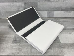 siena material faux leather document wallet in white with a black bookcloth lining