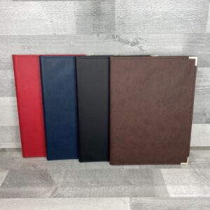 group of four clipboard folders in various colours including red, navy, brown, and black.